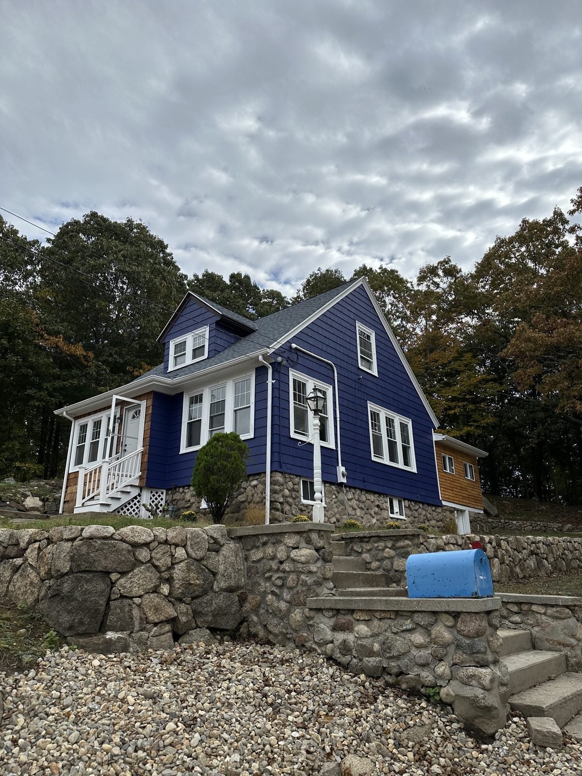 Exterior painting — after: finished blue house