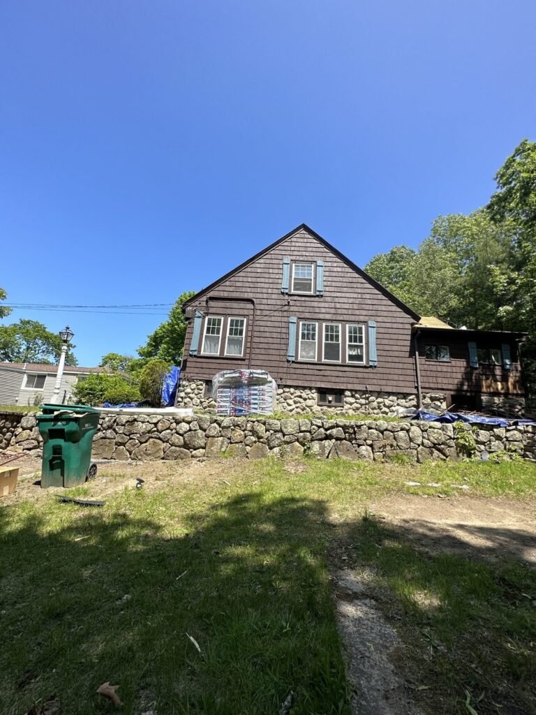 Exterior painting — before: weathered brown shingles, full house view