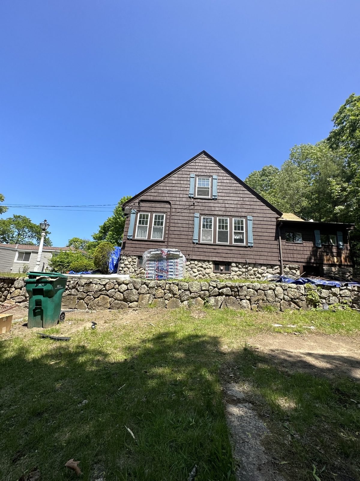 Exterior painting — before: weathered brown shingles, full house view