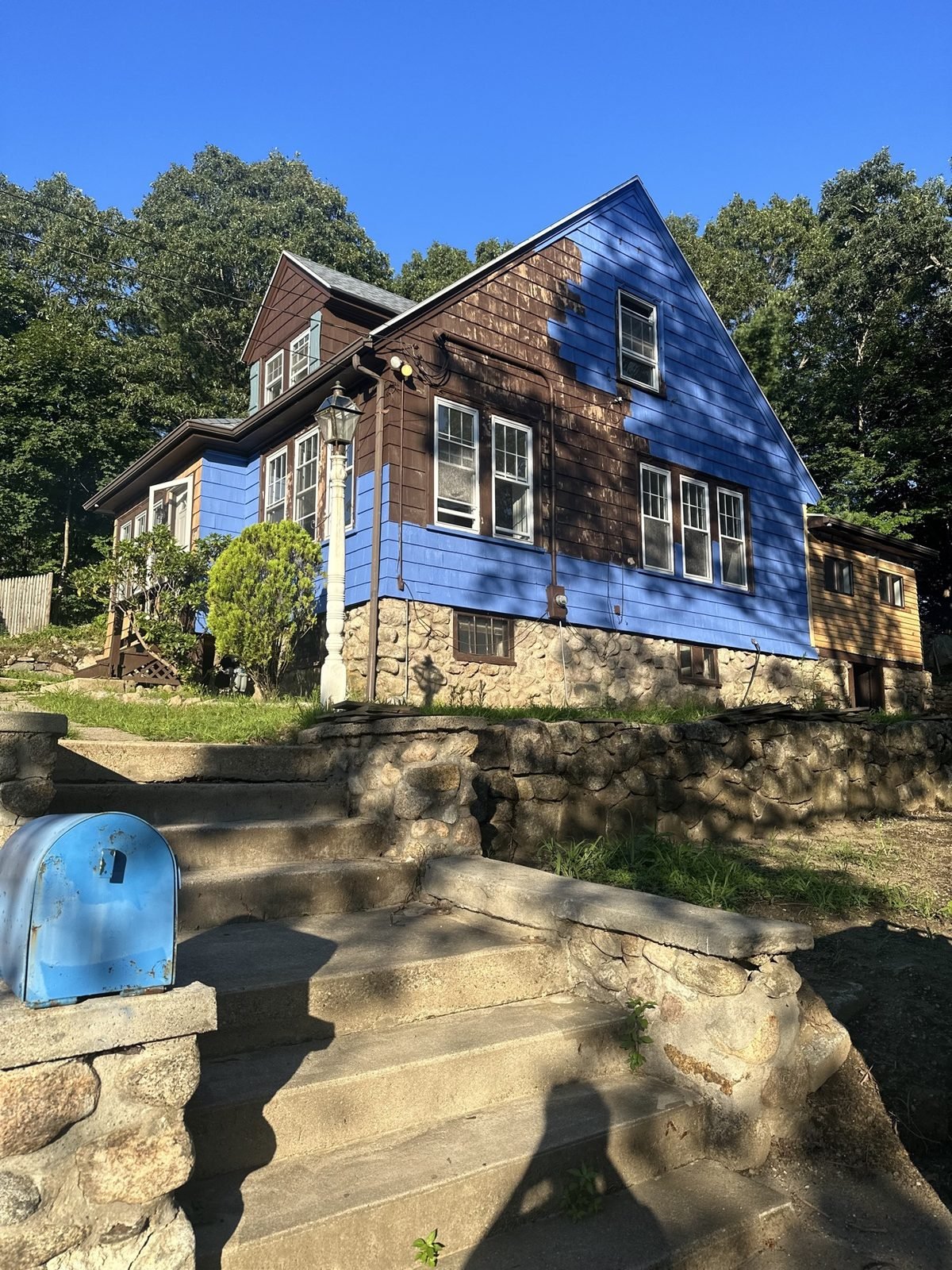 Exterior painting in progress — half painted