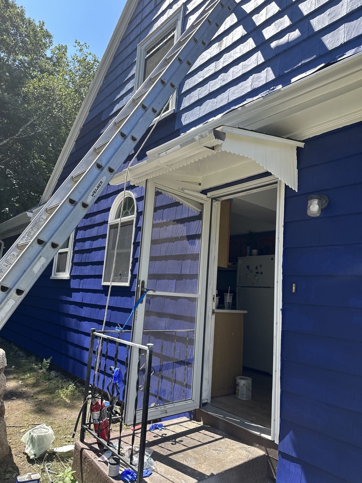 Exterior painting in progress — entrance area nearly finished